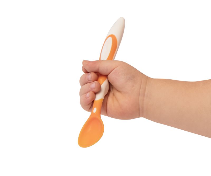 orange baby spoon on white background