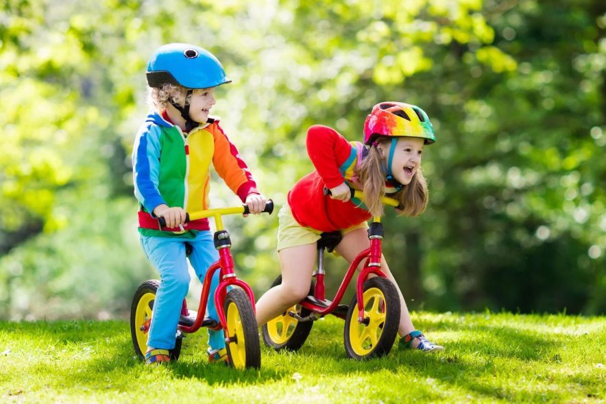 Children riding balance bikes 
