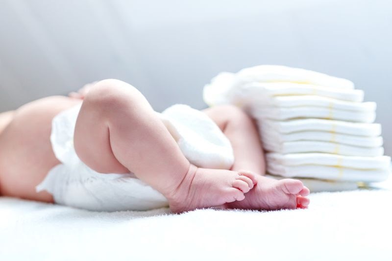 baby feet with diapers on its side