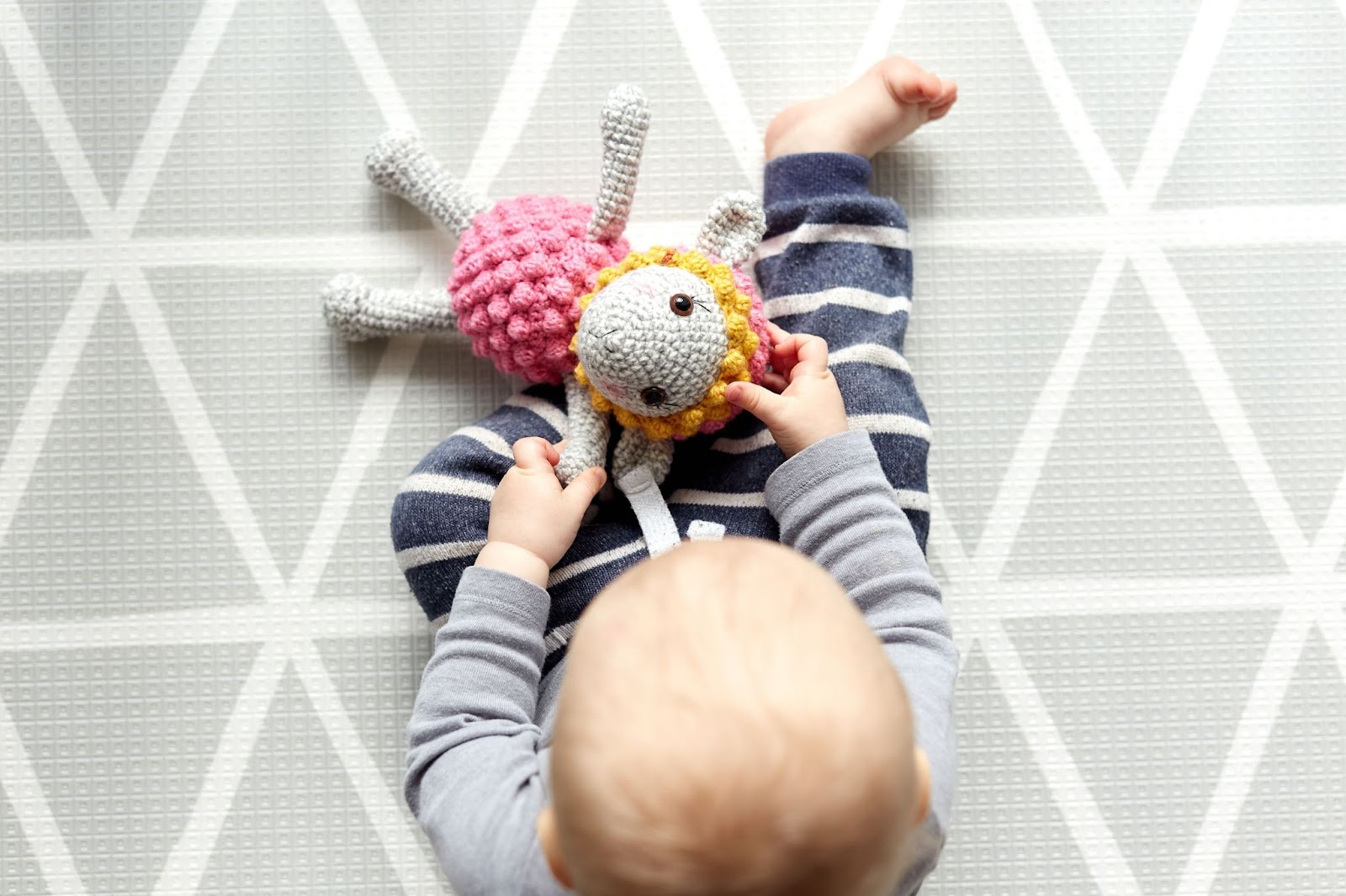 little-baby-playing-knit-toy-sheep