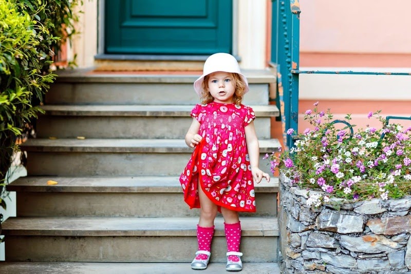 baby girl knee high socks - baby girl wearing pink outfit and posing on the front steps
