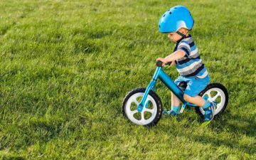 toddler bike without pedals - toddler boy riding a blue balance bike