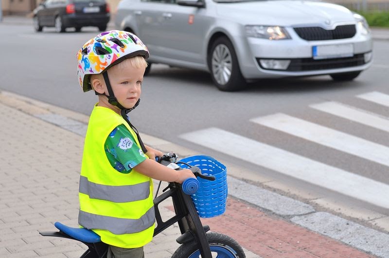 toddler girl bike helmet - child girl bike helmet - little boy looking around a pedestrian lane