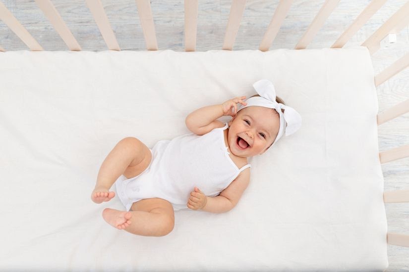 baby inside a white baby crib
