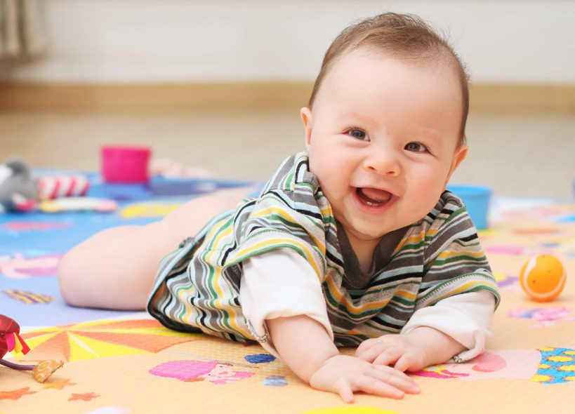 smiling baby in a play mat