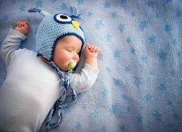 baby boy sleeping in blue blanket