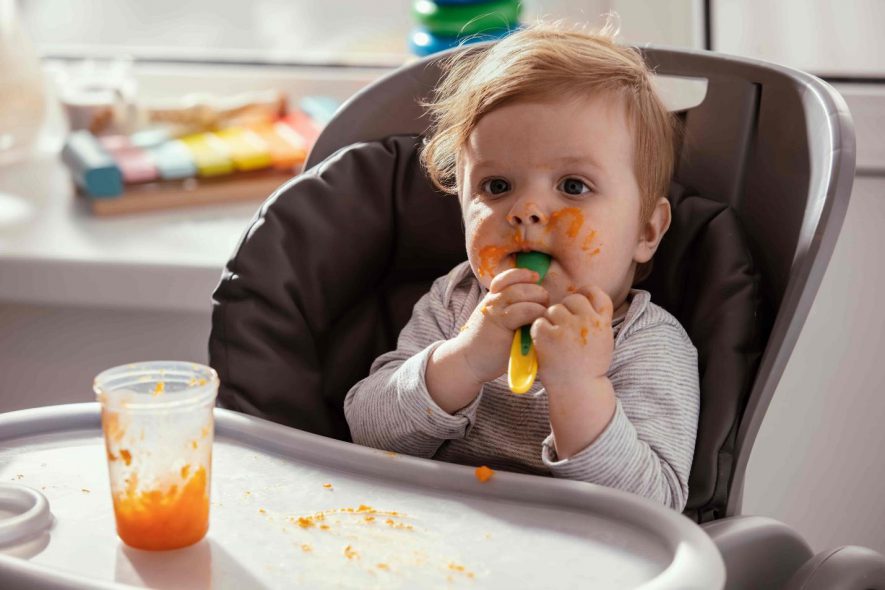 baby eating carrot puree 