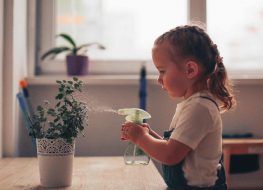 little girl watering plants