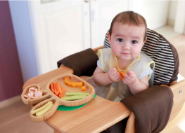 baby eating assortment of solid food