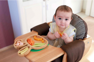 baby eating assortment of solid food