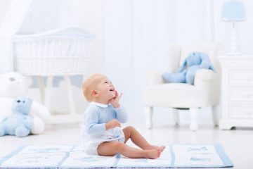 adorable baby playing in baby floor mat