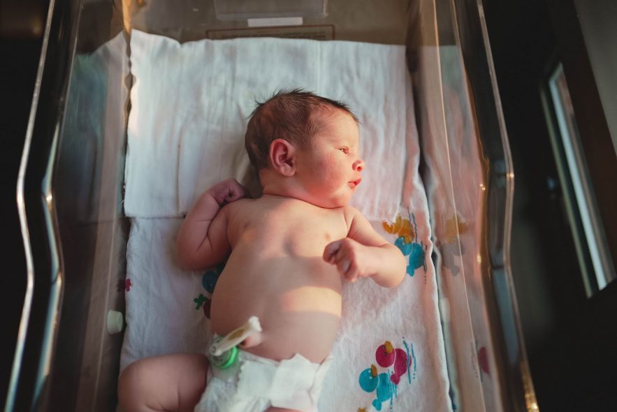 A baby looking out of his incubator