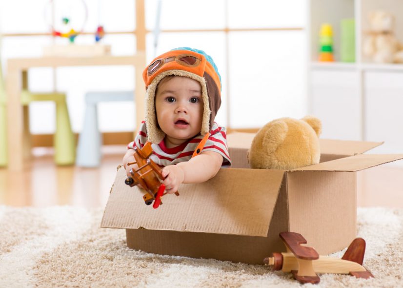 baby playing inside a box 