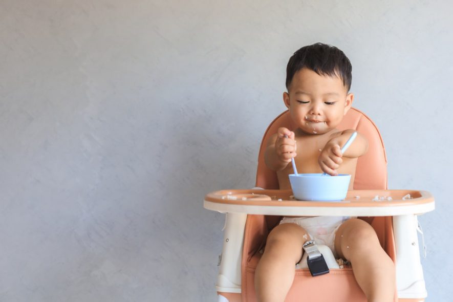 kid eating on high chair 