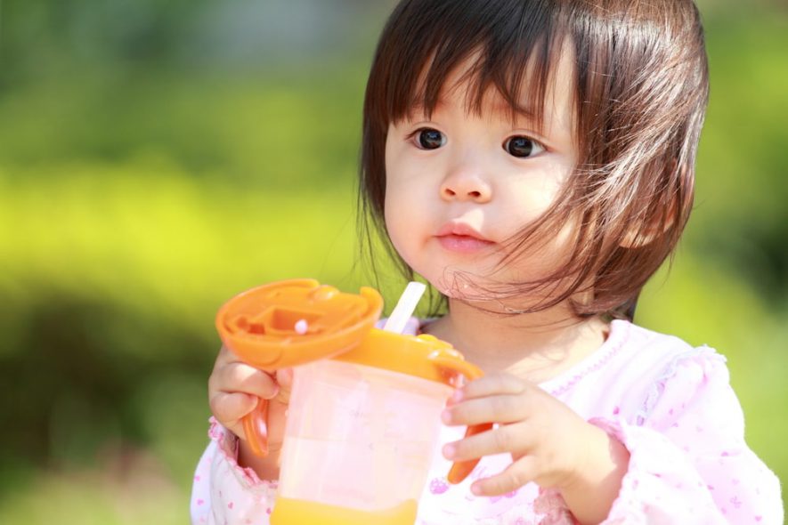 a Japanese baby girl using a straw cup