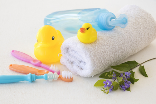 baby hygiene kit consisting of a baby toothbrush, towel, bottle, and rubber ducks