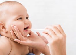 baby having oral hygiene check-up
