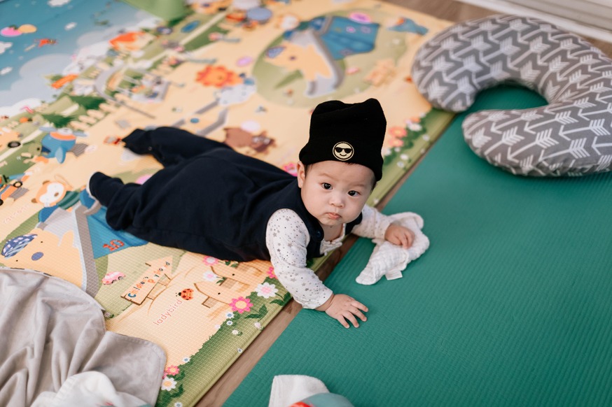 a baby doing tummy time on his play mat