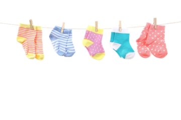 Different-colored baby socks hanging on a miniature clothesline.