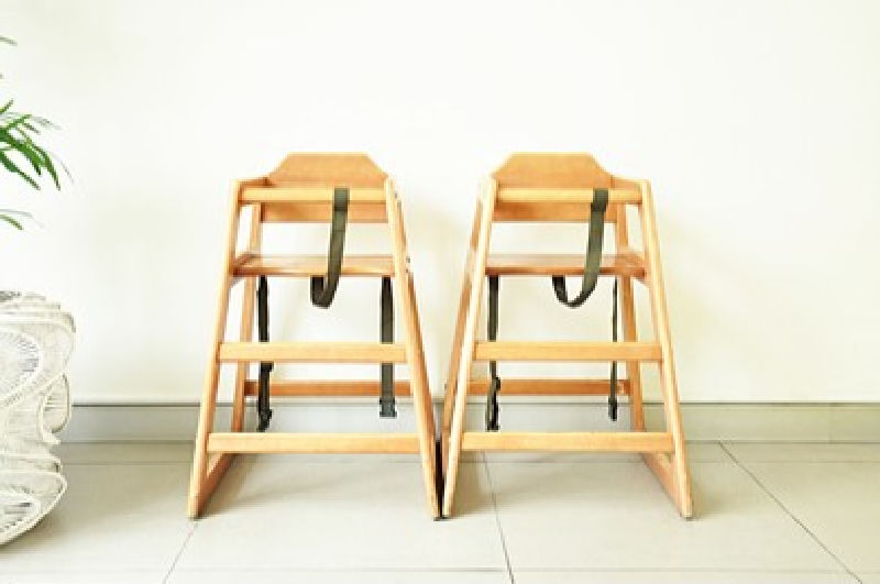 Wood high chair - Two wooden high chairs next to each other