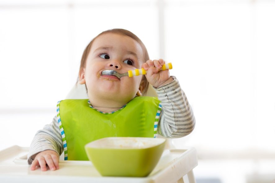 a baby wearing a bib while eating