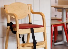 Wooden high chair for use in a public restaurant