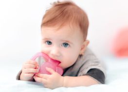 Baby chewing on a teether for baby