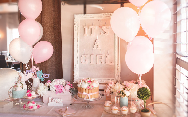 balloons, cakes, cupcakes, and decorations for a baby shower