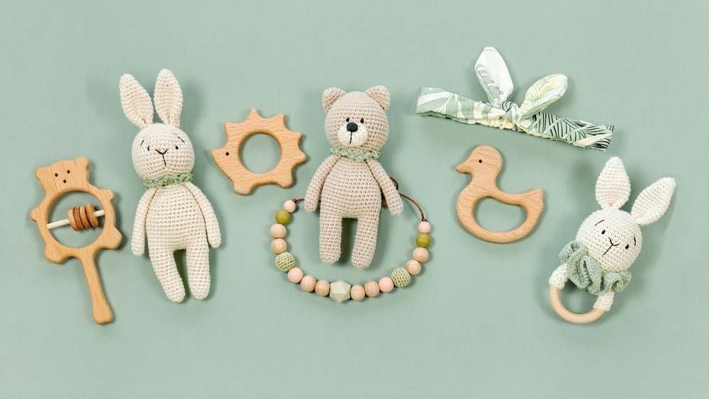 different animal shaped teething toys on a green background